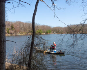 Visitor paddling a canoe on Clamshell Pond